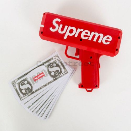 Пистолет стрелящ банкноти